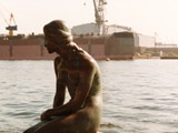 The Little Mermaid is a bronze statue by Edvard Eriksen, depicting a mermaid becoming human. The sculpture is displayed on a rock by the waterside at the Langelinie promenade in Copenhagen, Denmark. It is 1.25 metres tall and weighs 175 kilograms