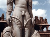 Believed to be the world's largest monolithic stone statue, Gomateshwara is a monolithic statue standing at 60 feet (18 m) above a hill in a place called Shravanabelagola in the Hassan district of Karnataka state, India. The statue was built by the Ganga minister and commander Chamundaraya in honour of Lord Bahubali. It was built in the 10th century AD and is the size Jains believe humans used to be. Hundreds of thousands of pilgrims, devotees and tourists from all over the world flock to the statue once in 12 years for an event known as Mahamastakabhisheka